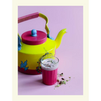 Colorful teapot with a glass of milk and cookies on a pink background